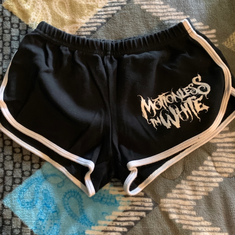 Motionless in white booty shorts.